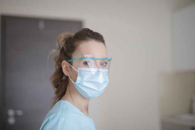 woman in blue shirt wearing face mask